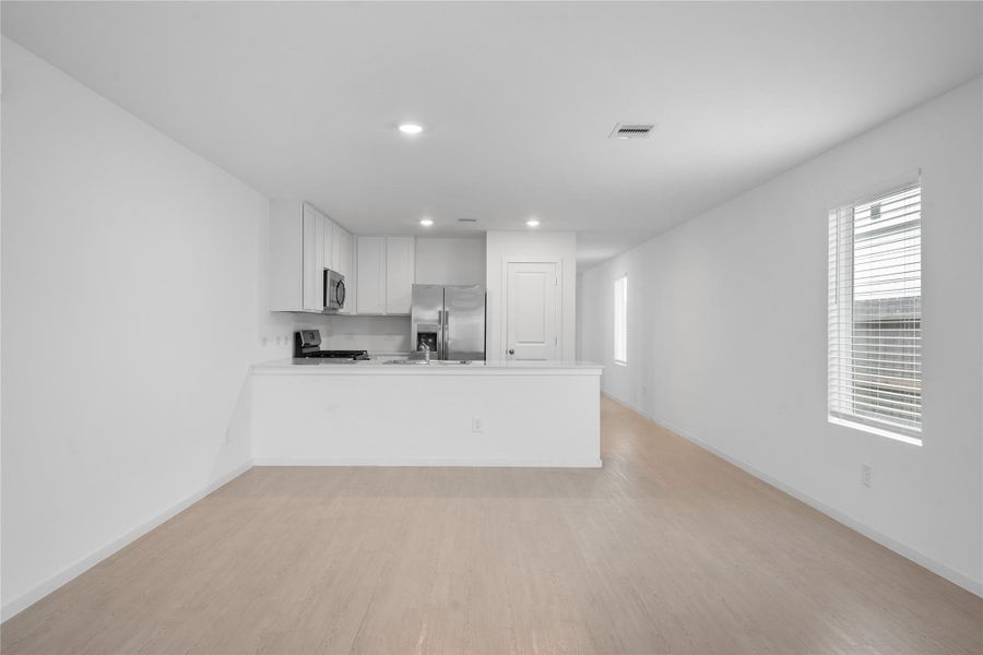 Recessed lighting, ample counter space and room for bar stools make this kitchen both functional and inviting.