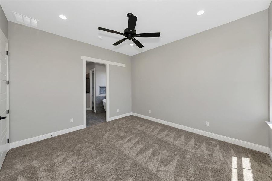 Unfurnished bedroom with carpet floors, recessed lighting, ensuite bath, and a ceiling fan