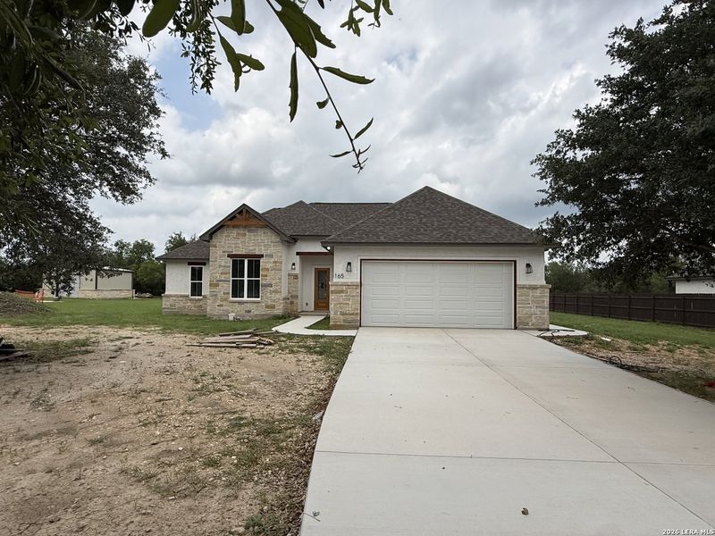 Front exterior of a new home in , Lytle, TX, highlighting curb appeal (Image 26).
