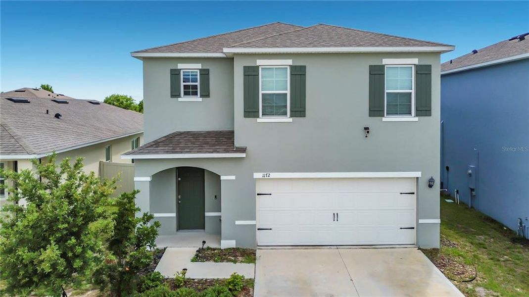 Front exterior of a new home in , Davenport, FL, highlighting curb appeal (Image 27). Front exterior of a new home in , Davenport, FL, highlighting curb appeal (Image 27).