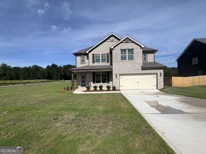 Front exterior of a new home in Harley Farms South, Bonaire, GA, highlighting curb appeal (Image 1). Front exterior of a new home in Harley Farms South, Bonaire, GA, highlighting curb appeal (Image 1).