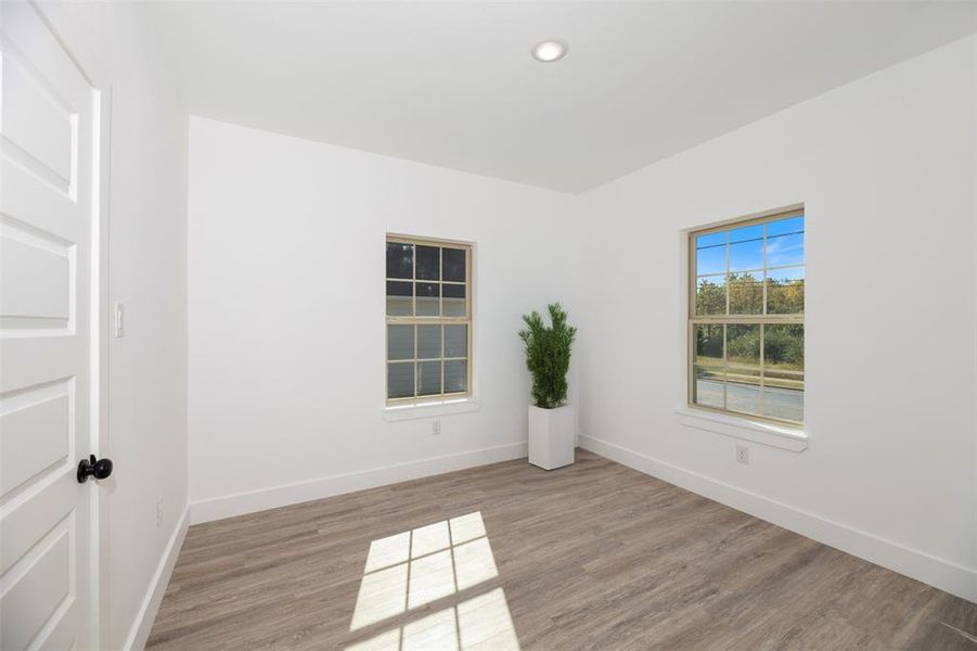 Unfurnished room with light wood-style flooring and recessed lighting Unfurnished room with light wood-style flooring and recessed lighting