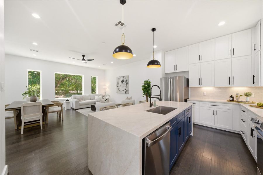 A beautifully designed modern kitchen with stunning accent fixtures. Natural light and trees that make you feel close to nature.