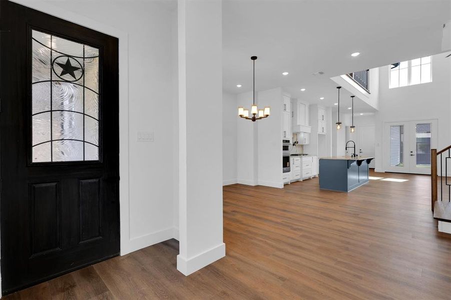 Entrance foyer with a chandelier, dark wood finished floors, and recessed lighting Entrance foyer with a chandelier, dark wood finished floors, and recessed lighting