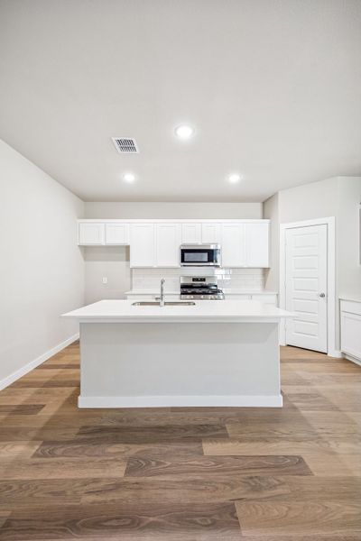 Kitchen in the Willow home plan by Trophy Signature Homes – REPRESENTATIVE PHOTO