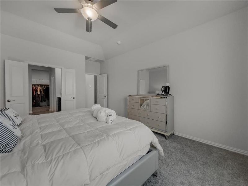 Bedroom featuring light carpet and ceiling fan