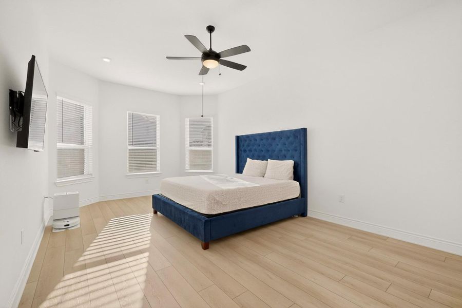 Bedroom with a ceiling fan and light wood finished floors