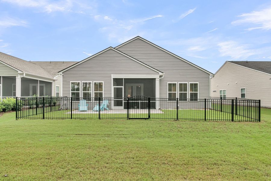 Exterior details and patio area of a home in K. Hovnanian's® Four Seasons at Lakes of Cane Bay, Summerville (Image 26).
