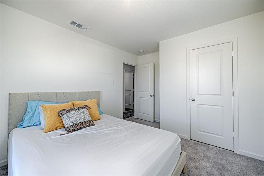 Carpeted bedroom with baseboards Carpeted bedroom with baseboards