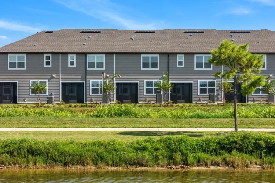 Front exterior of a new home in Catamaran Cove, Rockledge, FL, highlighting curb appeal (Image 21).