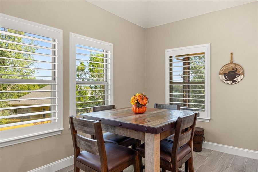 Dining area with baseboards and wood finish floors Dining area with baseboards and wood finish floors