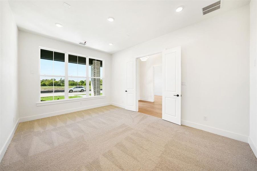 Spare room with light colored carpet and recessed lighting