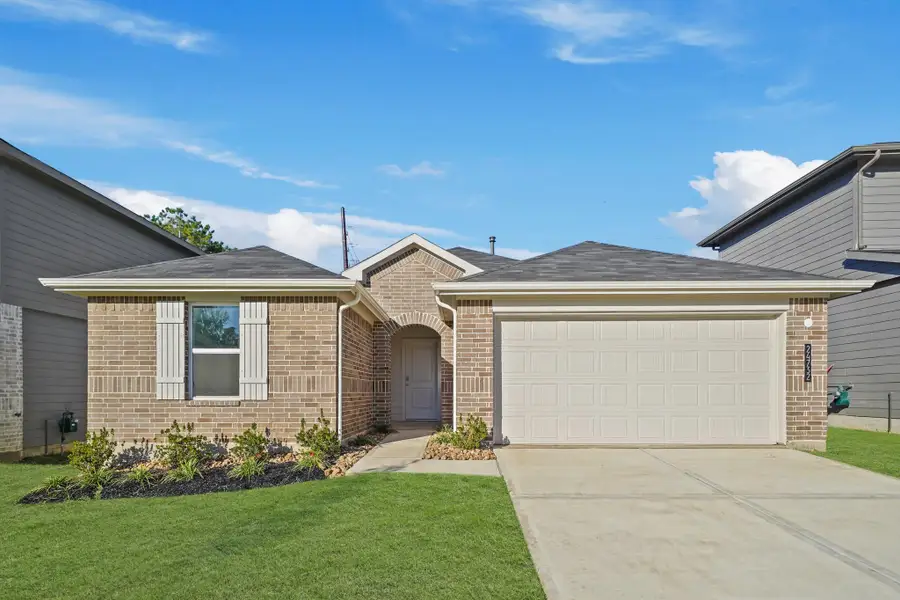 Front exterior of a new home in Grand Pines, Magnolia, TX, highlighting curb appeal (Image 2). Front exterior of a new home in Grand Pines, Magnolia, TX, highlighting curb appeal (Image 2).