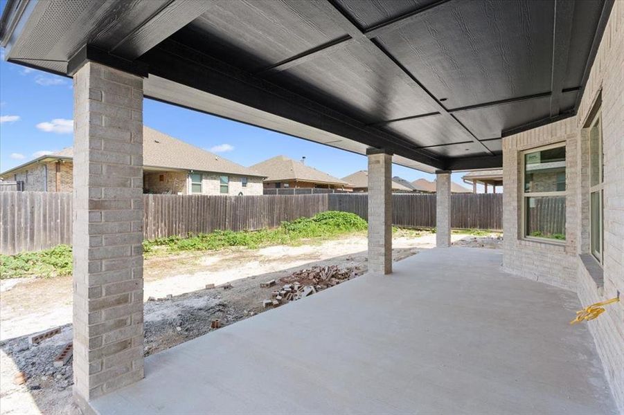 Fenced backyard with a patio area Fenced backyard with a patio area