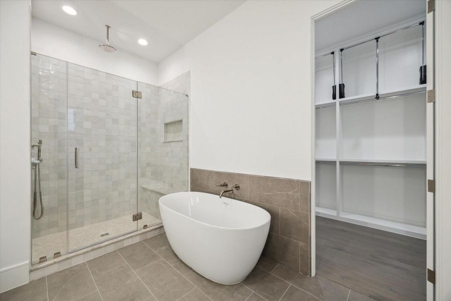 Shower features stacked square tile walls and niche with mosaic herribgone floor design and Laticrete rain shower head. Shower features stacked square tile walls and niche with mosaic herribgone floor design and Laticrete rain shower head.