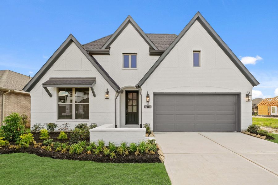 Front exterior of a new home in Bridgeland 55', Cypress, TX, highlighting curb appeal (Image 1). Front exterior of a new home in Bridgeland 55', Cypress, TX, highlighting curb appeal (Image 1).