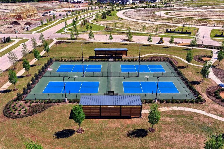 Community amenities include four pickleball courts with perimeter fencing and two sheltered seating areas