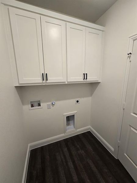 Washroom with hookup for a gas dryer, dark hardwood / wood-style floors, hookup for a washing machine, cabinets, and electric dryer hookup