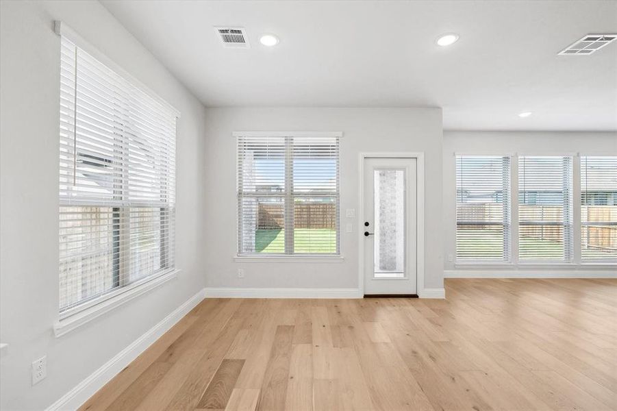Foyer with light wood-type flooring, baseboards, and recessed lighting