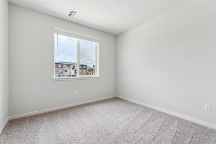 A room with a window and a tile floor.