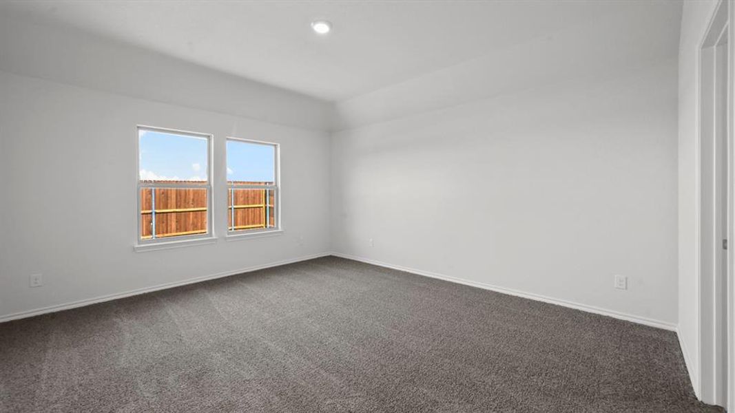 Spacious room with plush gray carpeting and white painted walls