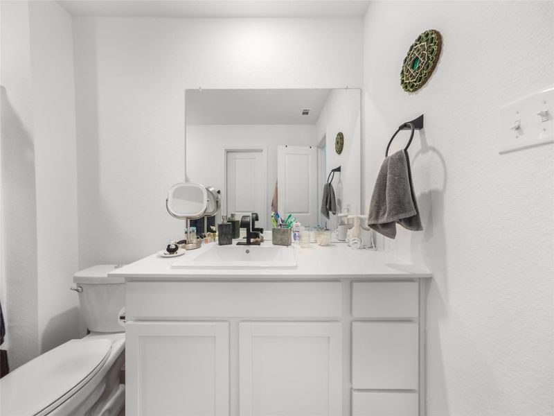 Bathroom with vanity and a textured wall