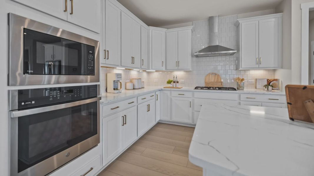The Stonefield Home Plan by DRB Homes in Belmont, NC. - Kitchen featuring an oversized bar and butler's panty