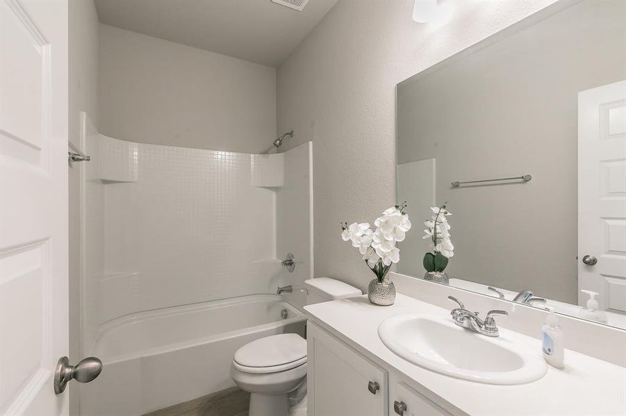 Full bath featuring shower / bathtub combination and vanity