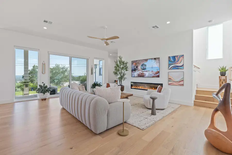 Wall-to-wall windows frame Lake Travis views, and panoramic hill country, flooding the living space with natural light. Wall-to-wall windows frame Lake Travis views, and panoramic hill country, flooding the living space with natural light.
