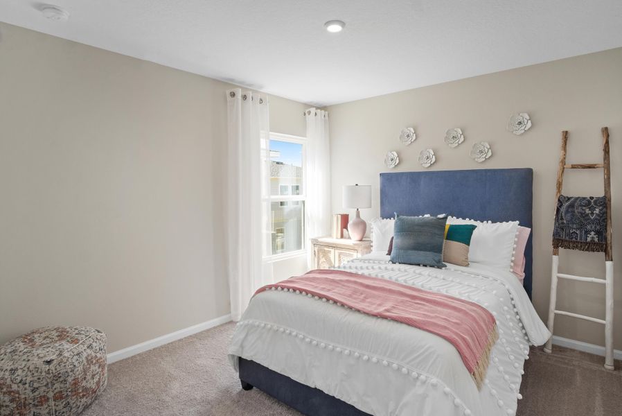 A bedroom with a bed and a window.