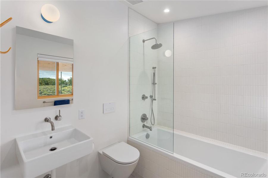 Full en suite bathroom for Unit 1 with oversized soaking tub.