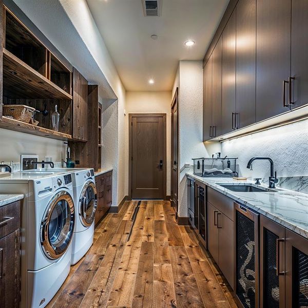 Laundry area with visible vents, a sink, wine cooler, light wood-style floors, and washer and dryer