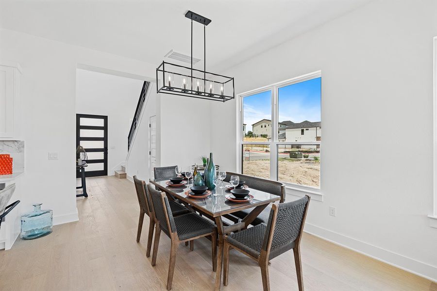 Dining room with ample spacing yet open floor plan connects kitchen island making for a great gathering area
