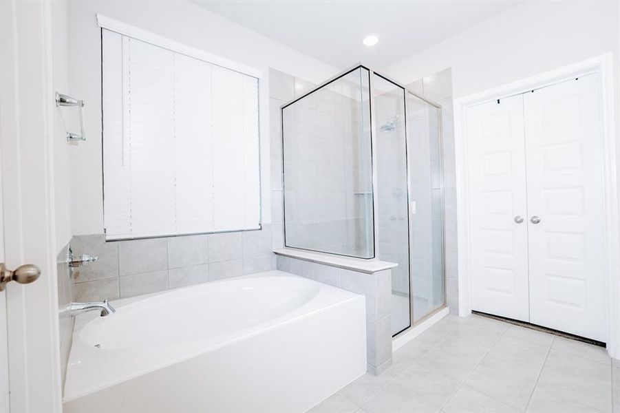 Bathroom featuring tile patterned flooring and independent shower and bath