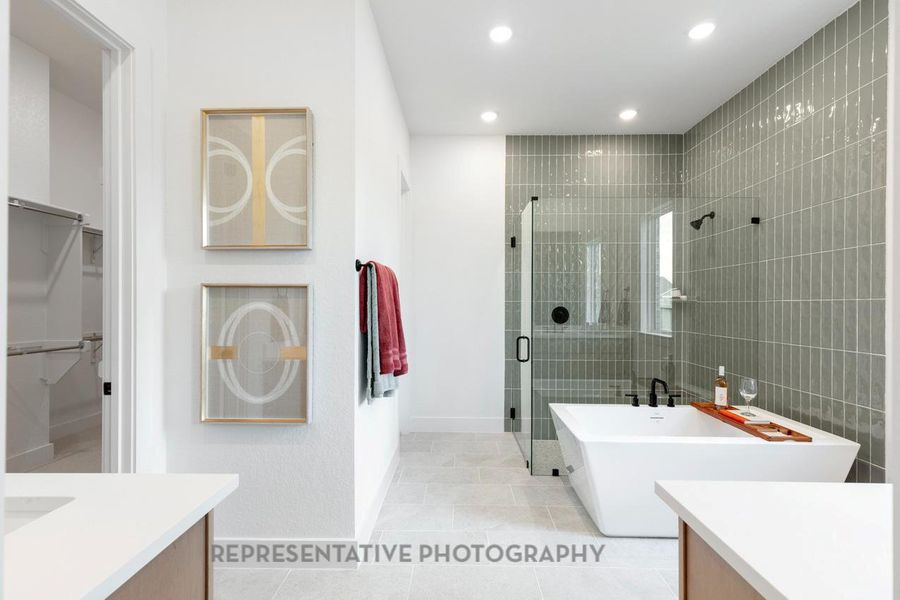 Bathroom with vanity, a shower stall, a soaking tub, light tile patterned floors, and recessed lighting