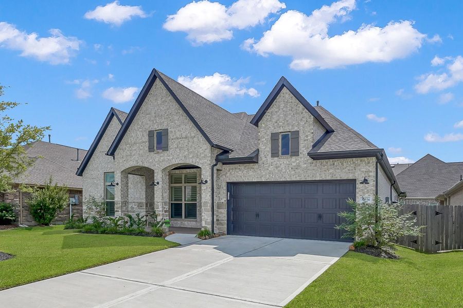 Front exterior of a new home in The Meadows at Imperial Oaks, Conroe, TX, highlighting curb appeal (Image 22). Front exterior of a new home in The Meadows at Imperial Oaks, Conroe, TX, highlighting curb appeal (Image 22).