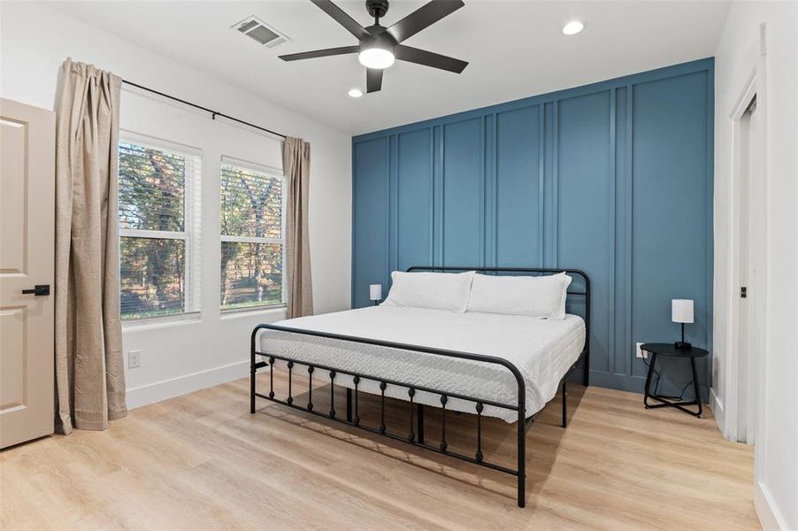 Bedroom with light hardwood / wood-style floors and ceiling fan
