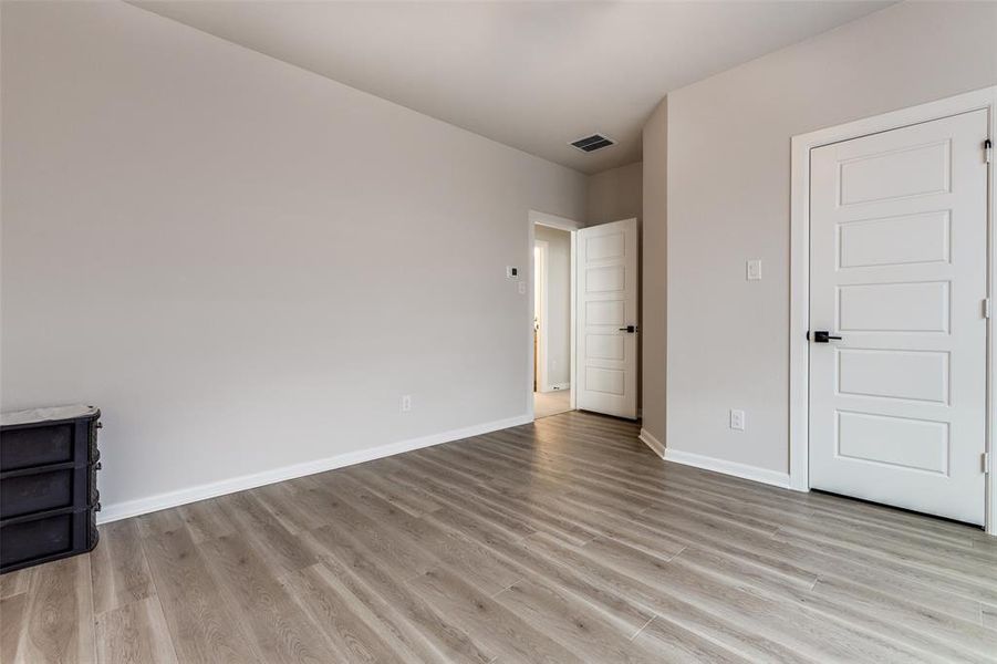 Unfurnished bedroom featuring light wood-style flooring and baseboards