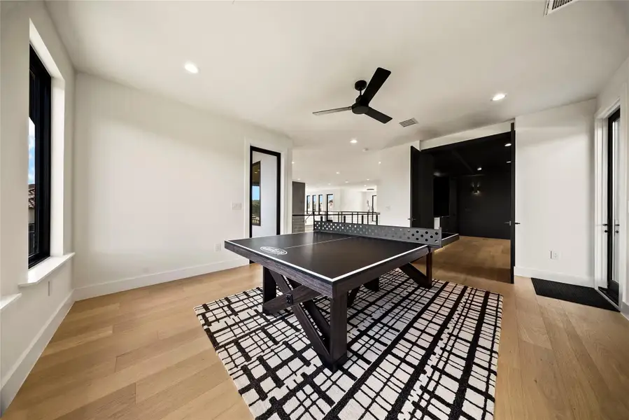 Rec room featuring a ceiling fan, light wood-type flooring, and recessed lighting Rec room featuring a ceiling fan, light wood-type flooring, and recessed lighting