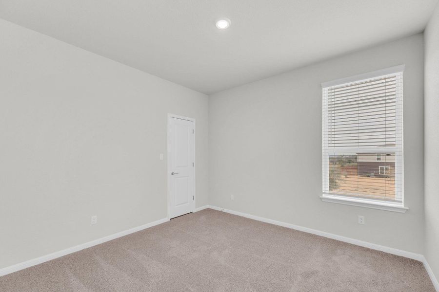 Spare room featuring light carpet and recessed lighting