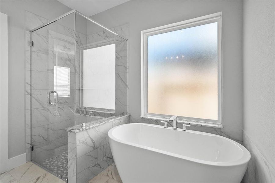 This additional view of the primary bath showcases the oversized walk-in shower with tile surround and the separate garden tub for soaking after a long day.