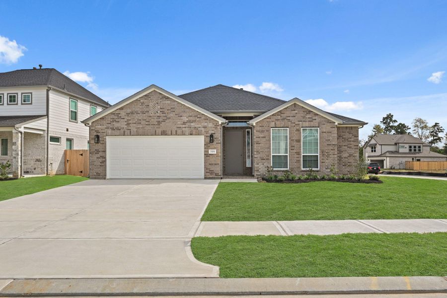Front exterior of a new home in Barton Creek Ranch, Conroe, TX, highlighting curb appeal (Image 1).