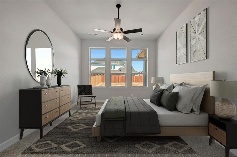 Carpeted bedroom with baseboards and a ceiling fan