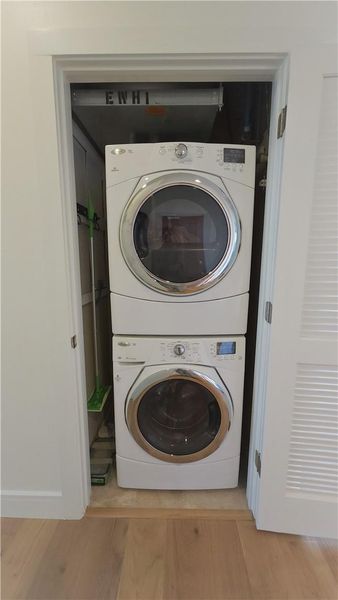 Full-size washer & dryer remain with unit. Broom, ironing board, detergent storage on the sides. Hot water booster installed in-line for maximum capacity.