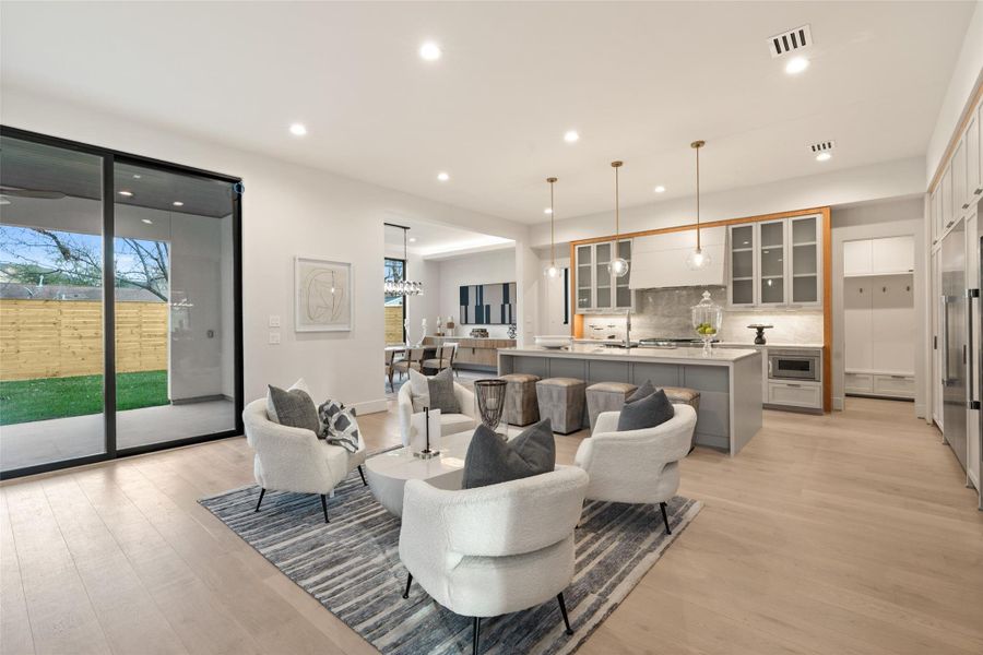 Open-concept living area with expansive windows for natural light. Seamless flow ideal for both every day living and entertaining. Open-concept living area with expansive windows for natural light. Seamless flow ideal for both every day living and entertaining.