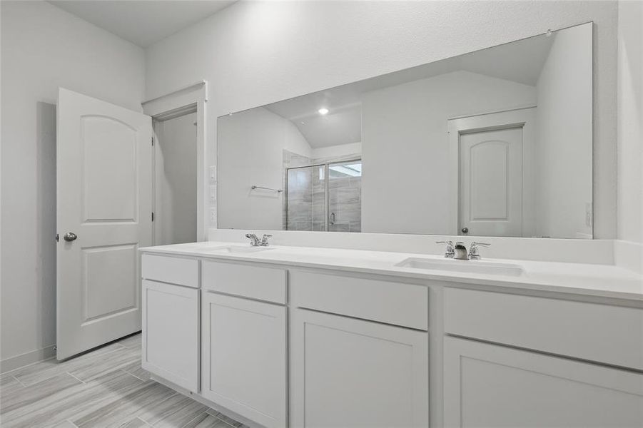 Full bathroom with double vanity, a sink, and a stall shower Full bathroom with double vanity, a sink, and a stall shower