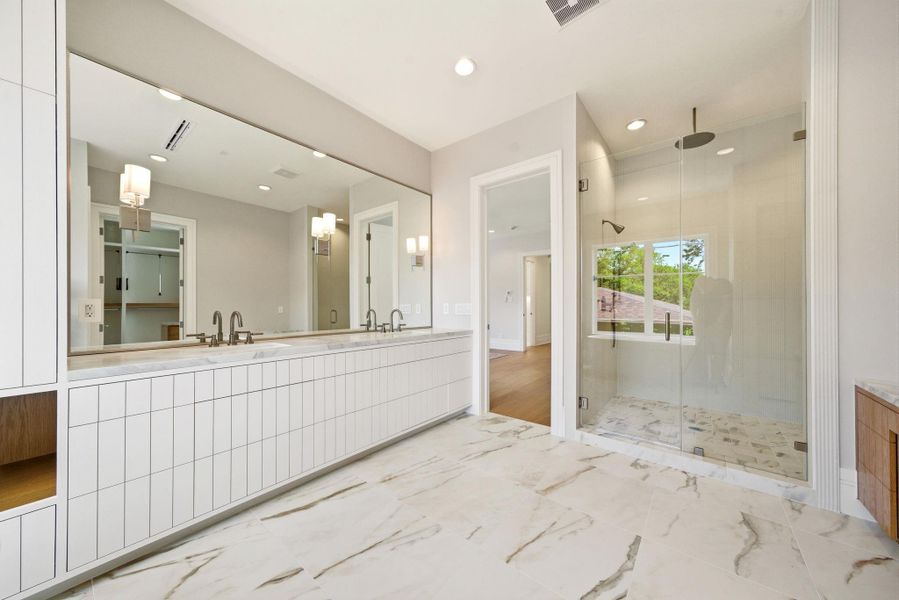 Gorgeous primary bath with oversized dual vanity, frameless glass shower, and elegant spa-like finishes. Gorgeous primary bath with oversized dual vanity, frameless glass shower, and elegant spa-like finishes.