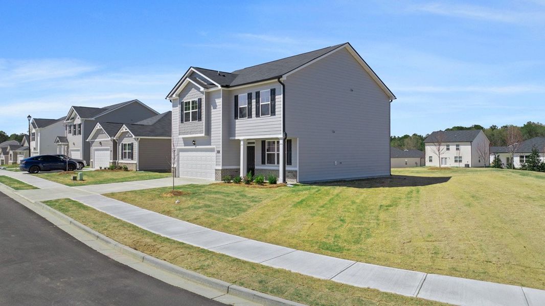 Front exterior of a new home in Champion's Run, Lithonia, GA, highlighting curb appeal (Image 2). Front exterior of a new home in Champion's Run, Lithonia, GA, highlighting curb appeal (Image 2).