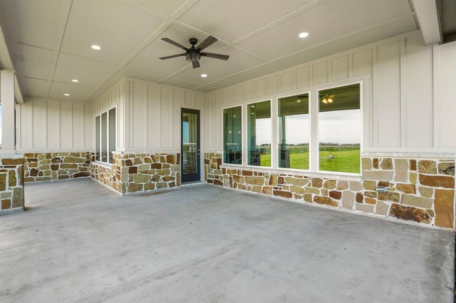 This covered Back Porch is accessible from the Kitchen and Breakfast Room and boasts stacked stone pillars, high ceiling, recessed lighting, and a ceiling fan. With a space of this size this area can function as an outdoor living room AND outdoor dining.