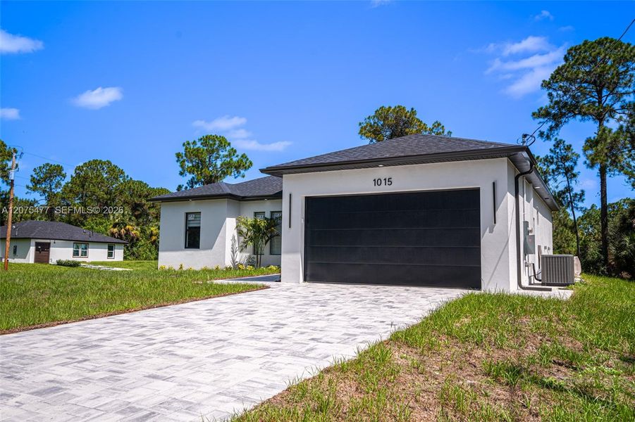 Front exterior of a new home in , Lehigh Acres, FL, highlighting curb appeal (Image 30). Front exterior of a new home in , Lehigh Acres, FL, highlighting curb appeal (Image 30).